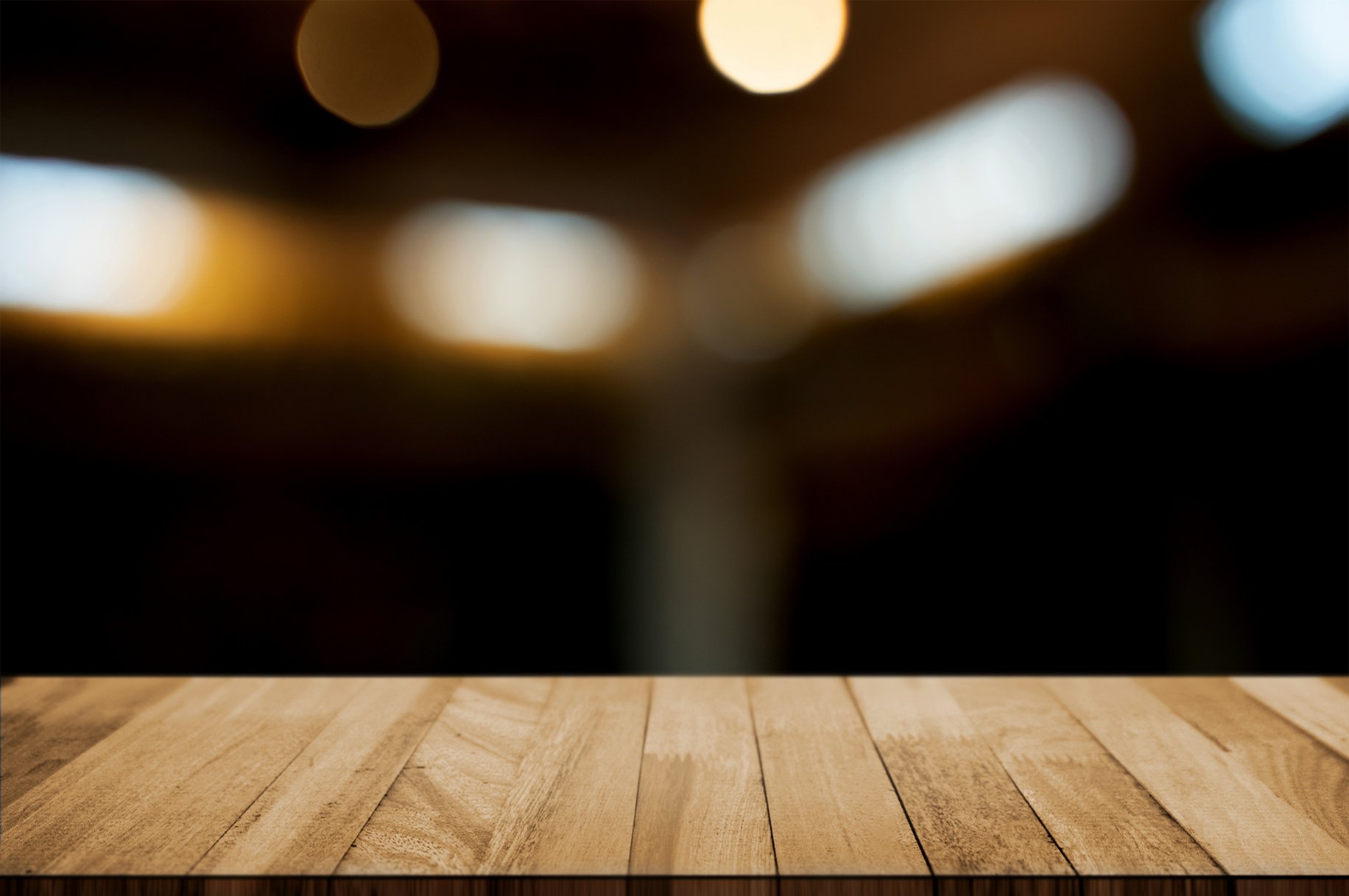 Wooden tabletop in front of montage blur restaurant cafe or kitchen background.